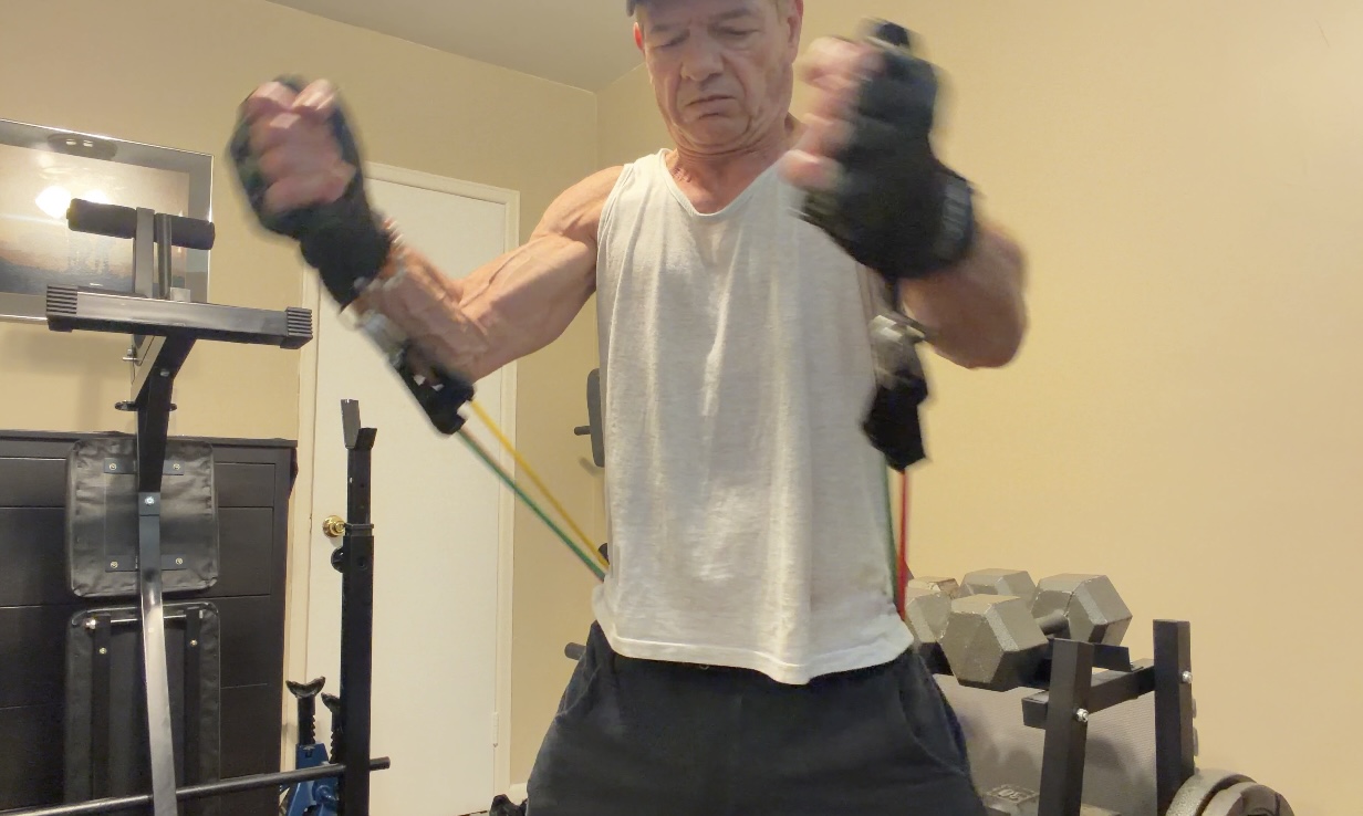 John bringing the handles together at the finish of a resistance-band chest fly