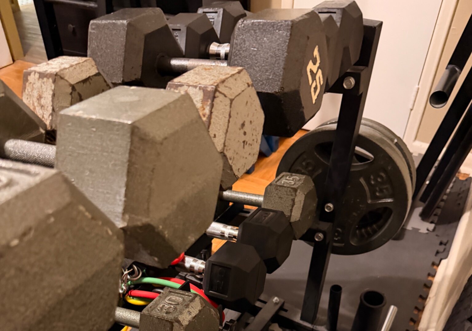 John’s collection of dumbbells arranged on his home gym rack