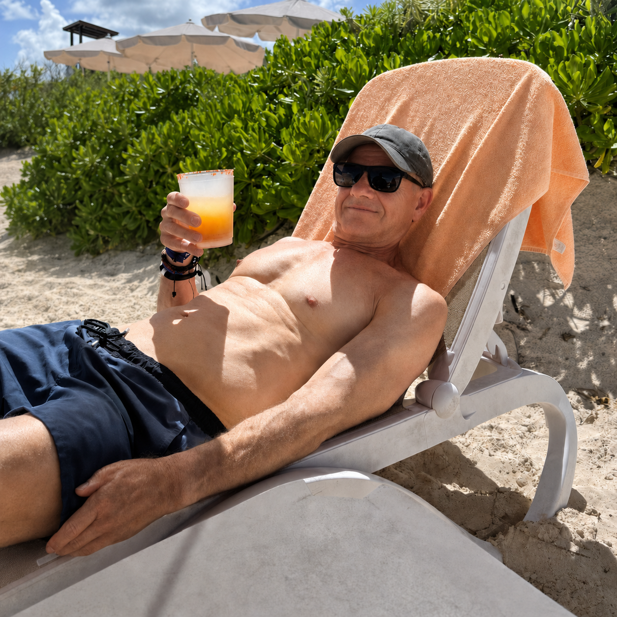 John smiling and relaxing on a beach after staying active