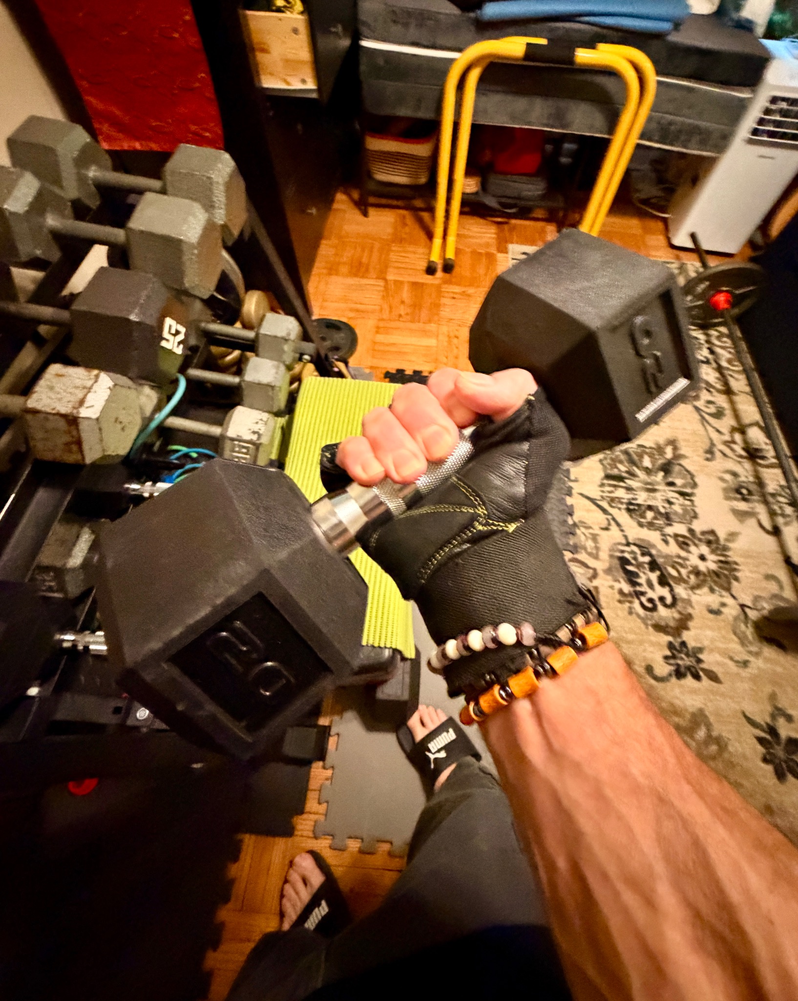 John gripping a heavy dumbbell in his home gym