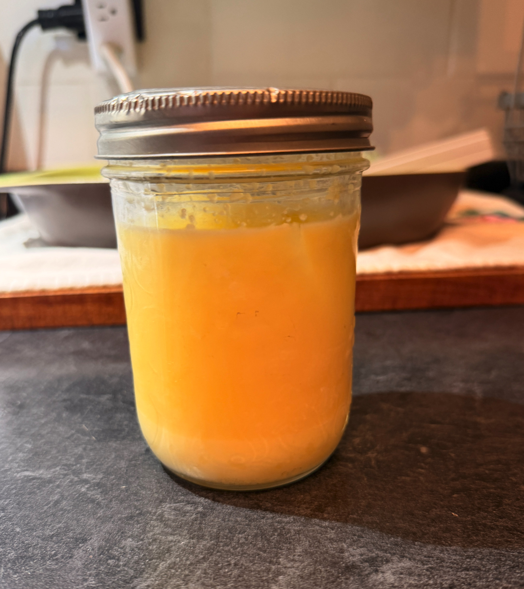 John's finished golden homemade ghee in a sealed mason jar