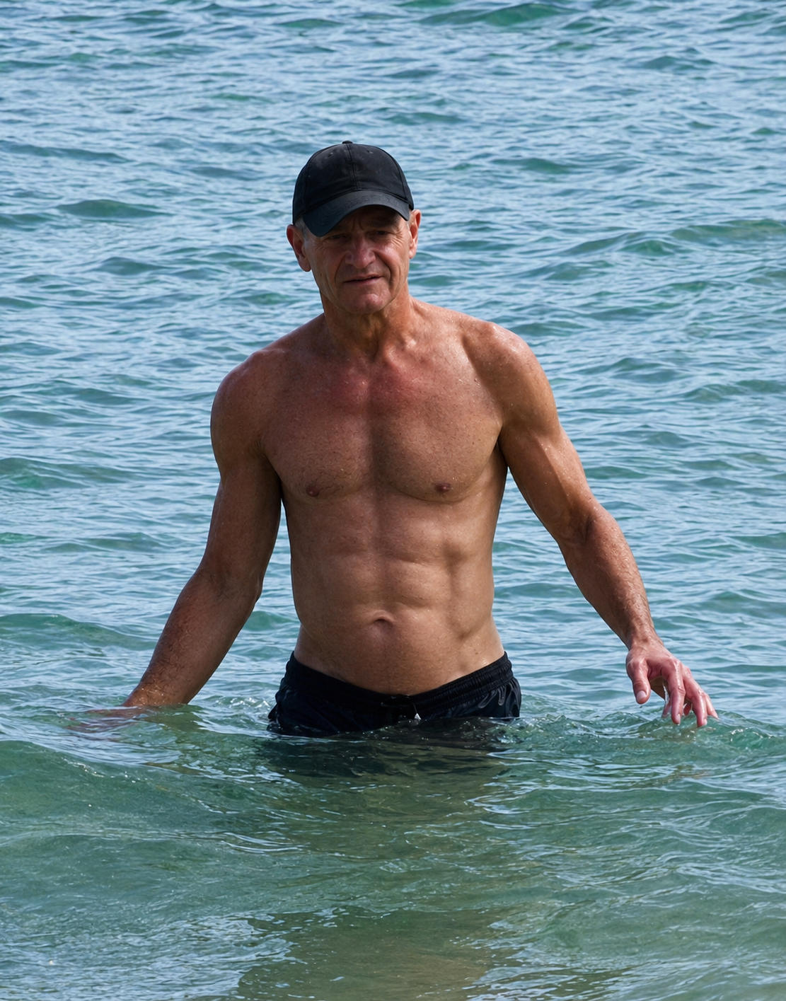 John standing in the ocean, strong and fit at 63