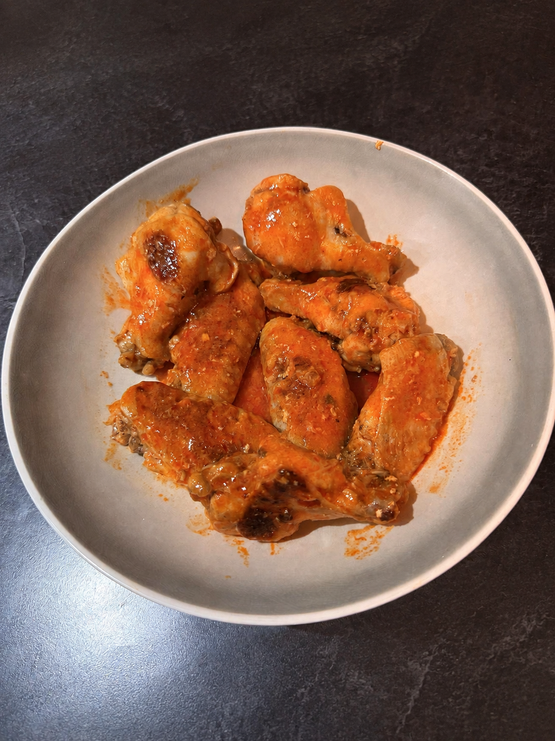 John's finished cream-and-ghee wings tossed in buttery hot sauce