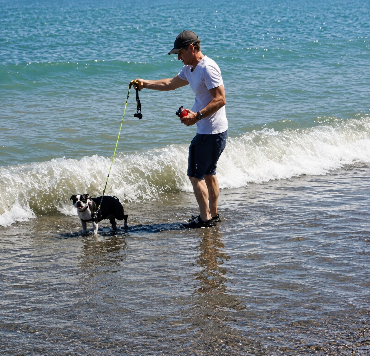 John standing with his dog at the water’s edge